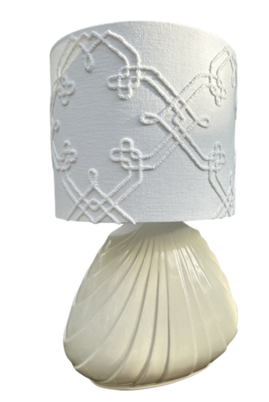 Vintage ivory ceramic shell table lamp illuminated