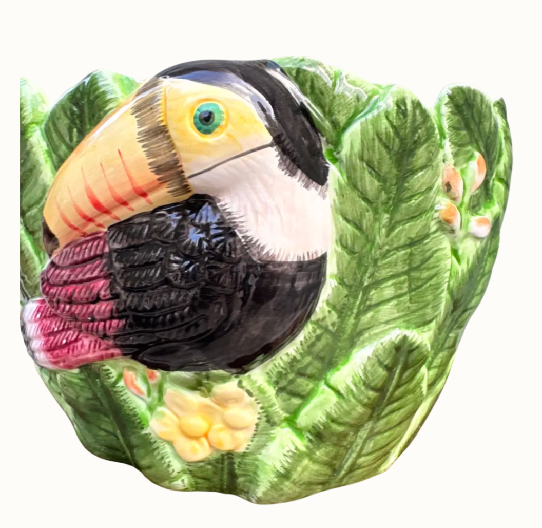 Detail of yellow and black hand-painted ceramic toucan