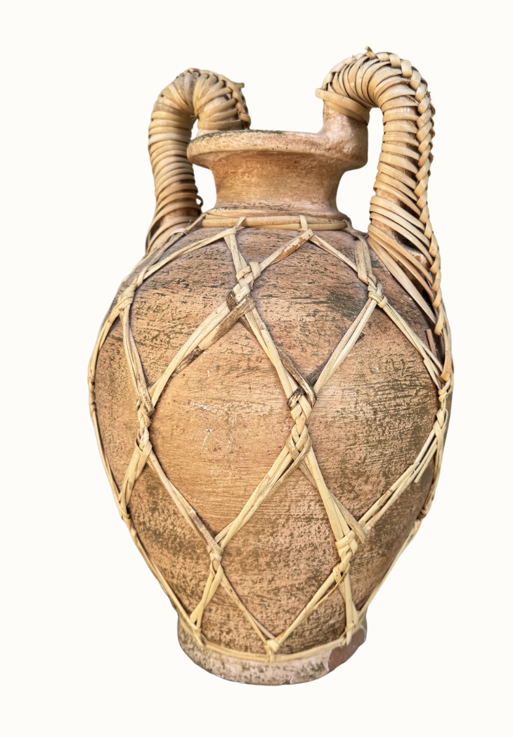Close-up of handwoven rattan lattice on terracotta vessel